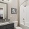 bathroom with bathtub and large mirror